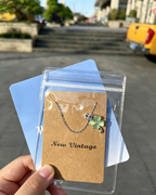 Packaged in green wrapping Four‑Leaf Clover Necklace