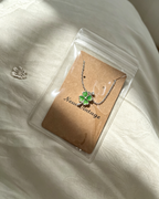 Packaged in green wrapping Four‑Leaf Clover Necklace